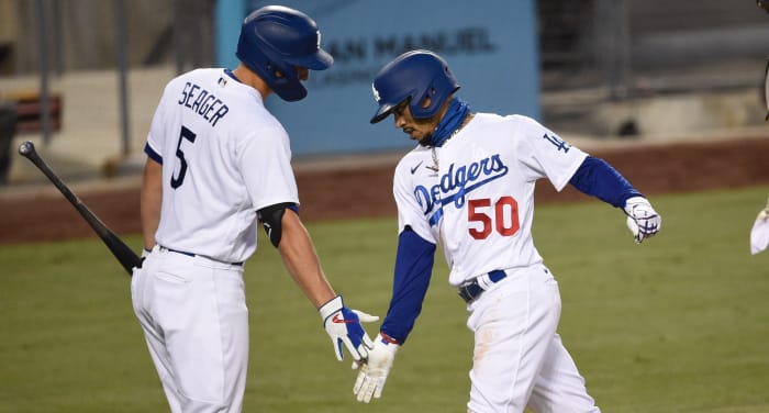 Los Angeles Dodgers right fielder Mookie Betts (50) celebrates his solo home run with shortstop Corey Seager (5) during the fourth inning against the San Diego Padres at Dodger Stadium.